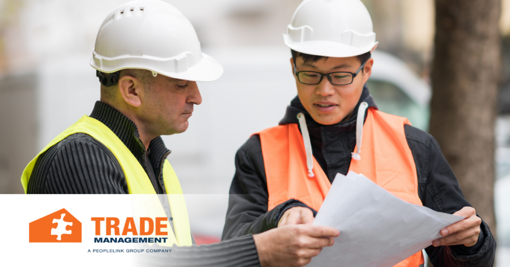 Skilled laborers reviewing project plans.