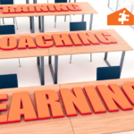 Text consisting of "training", "coaching", "learning" laid on desks.