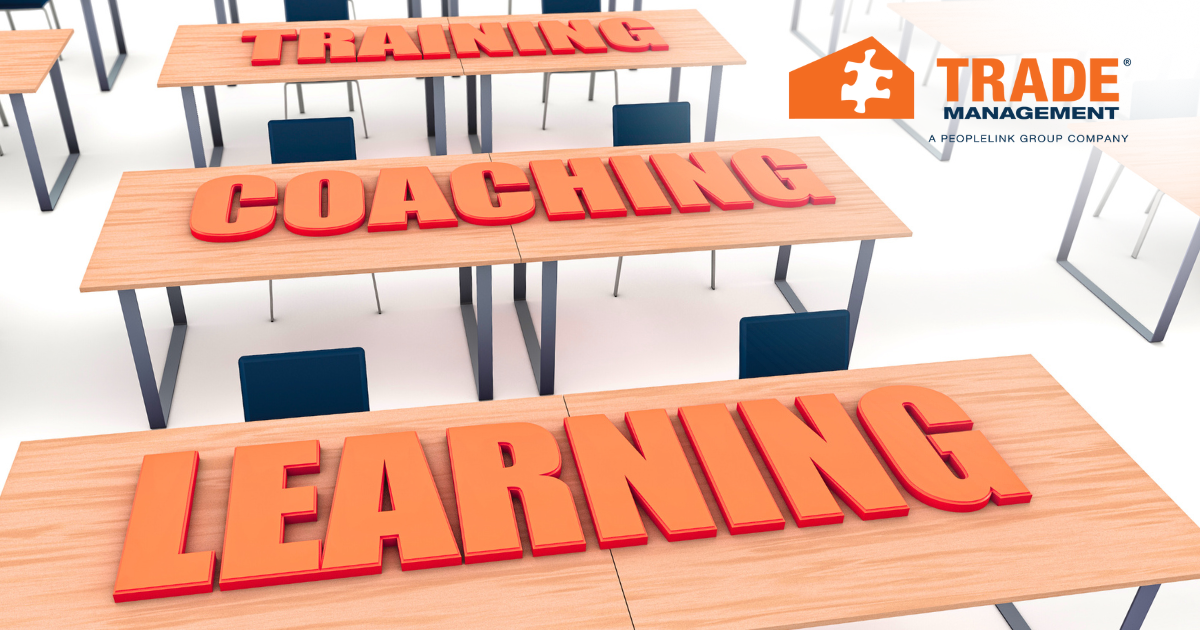 Text consisting of "training", "coaching", "learning" laid on desks.